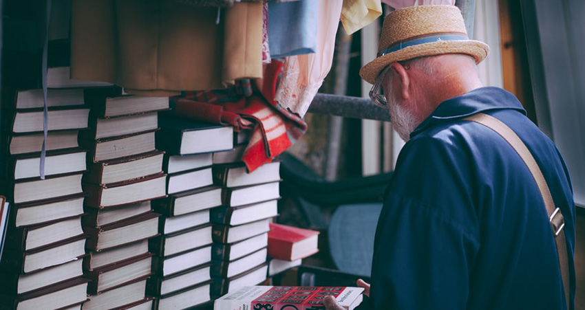 Elderly gentleman browsing books
