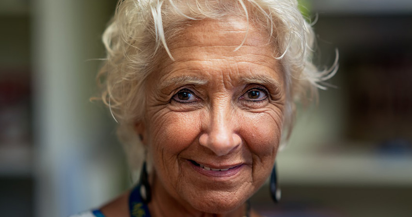 What age is considered elderly: An older woman smiling